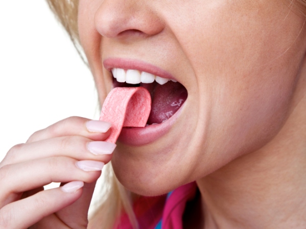 Woman putting gum in her mouth